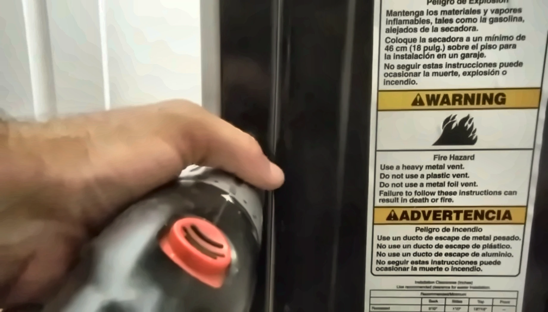 Clothes dryer repair Kenmore: fire hazard and metal vent warning label on a dryer